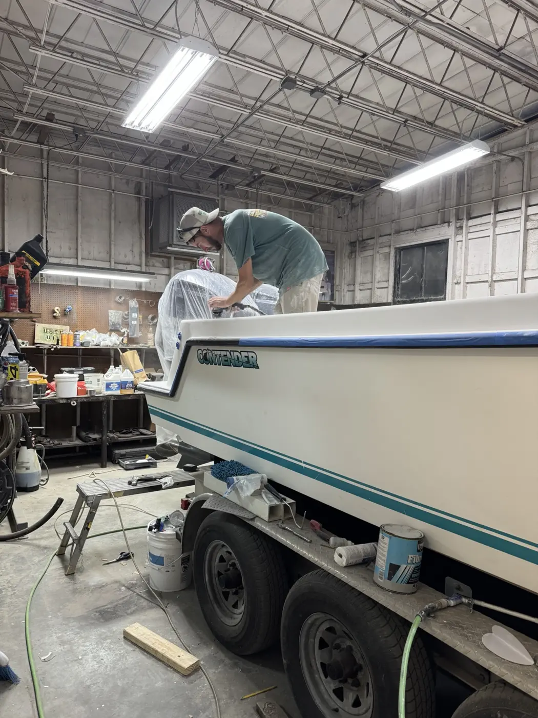 Port Royal Fiberglass shop — technician preparing hull